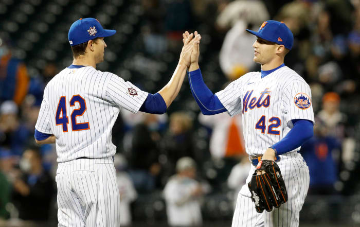Jacob deGrom #48 (L) of the New York Mets celebrates his shutout against the Washington Nationals with teammate Brandon Nimmo #9 at Citi Field on April 23, 2021 in New York City. All players are wearing the number 42 in honor of Jackie Robinson Day. The Mets defeated the Nationals 6-0.